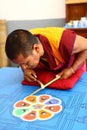 Buddhist monk making sand mandala.