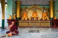 A Buddhist monk meditating in one of the shrines of the Shwedagon pagoda