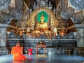 Orange robed monk in Buddhist temple