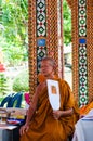 Buddhist monk poses for a photo at buddhist temple from Damnoen Saduak Floating Market Royalty Free Stock Photo
