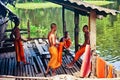 Buddhist monk pours water on Tonle Sap lake Royalty Free Stock Photo