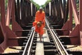 Buddhist monk on a railway bridge in Cambodia