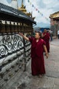 Buddhist monk spinning prayer wheels at Swayambhunath Stupa in Kathmandu Nepal Royalty Free Stock Photo