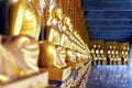 Buddhist monk statues at a cloister of Phra Maha Chedi, Roi Et, Thailand