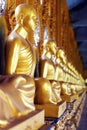 Buddhist monk statues at a cloister of Phra Maha Chedi, Roi Et, Thailand
