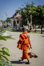 Buddhist monk walking outside Wat Svay Andet Pagoda in Kandal Province Cambodia