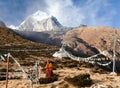 Buddhist monk, stupa and prayer flags near Pangboche Royalty Free Stock Photo