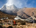 Buddhist monk stupa prayer flags near Pangboche monastery Royalty Free Stock Photo