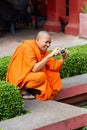 A buddhist monk taking a picture at the National Museum of Cambodia in Phnom Penh