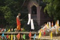 Buddhist monk with traditional flags.