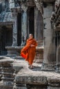 Buddhist monk walking in angkor wat cambodia Royalty Free Stock Photo