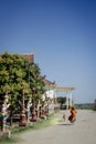 Buddhist monk walking outside Wat Svay Andet Pagoda in Kandal Province Cambodia