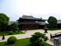 A Buddhist monk walking through temple