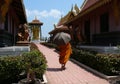 Buddhist Monk walking with Umbrella