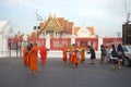 Buddhist monks collect food and offerings at the temple Wat Benchamabophit in the early morning. Bangkok,Thailand
