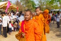 Buddhist monks collecting alms at a ceremony in rural Takeo province, Cambodia