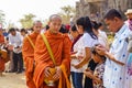 Buddhist monks collecting alms at a ceremony in rural Takeo province, Cambodia