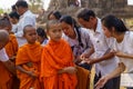 Buddhist monks collecting alms at a ceremony in rural Takeo province, Cambodia