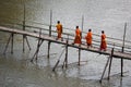 Buddhist Monks Crossing Bamboo Bridge in Luang Prabang, Laos