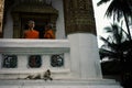 buddhist monks discussing something at the balcony of their monastery decorated with swastika symbols