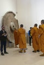 Buddhist monks examine sculptures at Sarnath