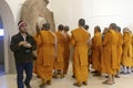 Buddhist monks examine sculptures at Sarnath