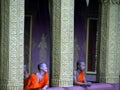 Buddhist Monks in orange robes relaxing in temple, Luang Prabang, Laos