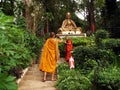 Buddhist monks photographing themselves next to the statue of a revered monk from Chiang Mai, Thailand