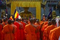 Buddhist monks praying in front of a temple.