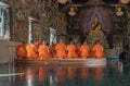 Buddhist Monks praying and pay respect Buddha statue at Wat Pariwas