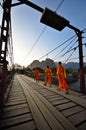 Buddhist monks and rusty bridge Royalty Free Stock Photo