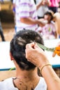 Buddhist monks shave their hair to be ordained Royalty Free Stock Photo