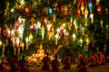 Buddhist monks sit meditating under a Bodhi Tree at the Wat Pan Tao temple