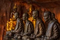 Buddhist monks statues symbol of peace and serenity at Wat Phu Tok temple, Thailand, asceticism and meditation, buddhist art work