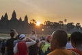 Buddhist monks and tourists at sunset at Angkor Wat