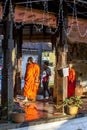 Buddhist monks walk through a temple within the Temple of the Sacred Tooth Relic complex in Kandy in Sri Lanka.