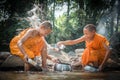 Buddhist novices are cleaning bowls and splashing water in the s
