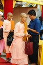 Buddhist nuns getting alms in line