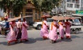 Buddhist nuns walking for morning alms on street in Mandalay, Myanmar Royalty Free Stock Photo