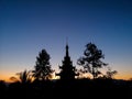 Buddhist pagoda and trees silhouette at sunset Royalty Free Stock Photo