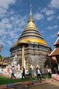 Buddhist people circle walk around main chedi at Wat Phra That Lampang Luang in Lampang province