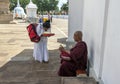 A Buddhist pilgrim is blessed by a Buddhist monk. Royalty Free Stock Photo