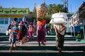 Buddhist pilgrims arriving at the Kyaiktiyo pagoda - Golden rock, carrying luggage on their shoulders. Families with kids visiting