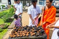 Buddhist pilgrims ligting candles into the shrine of Sri Dalada Maligawa or the Temple of the Sacred Tooth Relic, in Kandy, Sri