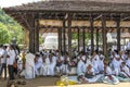 Buddhist pilgrims shelter from the sun within the Temple of the Sacred Tooth Relic in Kandy in Sri Lanka.