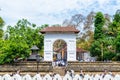 Buddhist pilgrims walking into the shrine of Sri Dalada Maligawa or the Temple of the Sacred Tooth Relic, in Kandy, Sri Lanka, Royalty Free Stock Photo