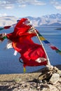 Buddhist prayer flags on the wind against blue lake Royalty Free Stock Photo