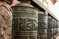 Buddhist prayer spinning drums with ancient mantras close up. Fixture for traditionhal Buddist prayer