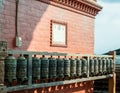 Buddhist prayer spinning drums with ancient mantras close up. Fixture for traditionhal Buddist prayer