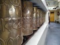 Buddhist prayer wheels made up of metal. A tibetan monastry on mountains.